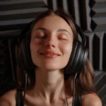 Woman enjoying music with headphones in a soundproof room
